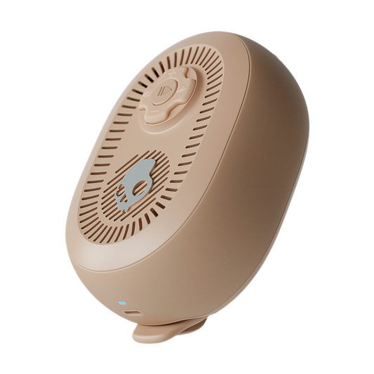 Beige portable speaker with a white background | Primer