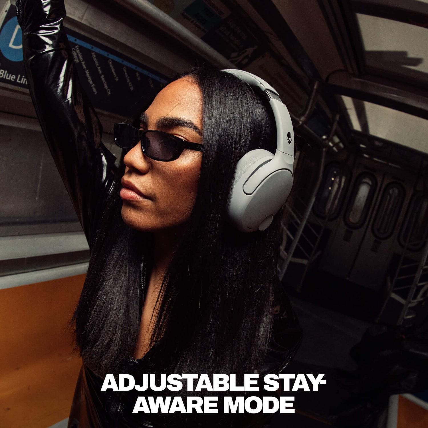 Person wearing Crusher 720 headphones and sunglasses inside a vehicle with text 'Adjustable Stay Aware Mode'. | Cement