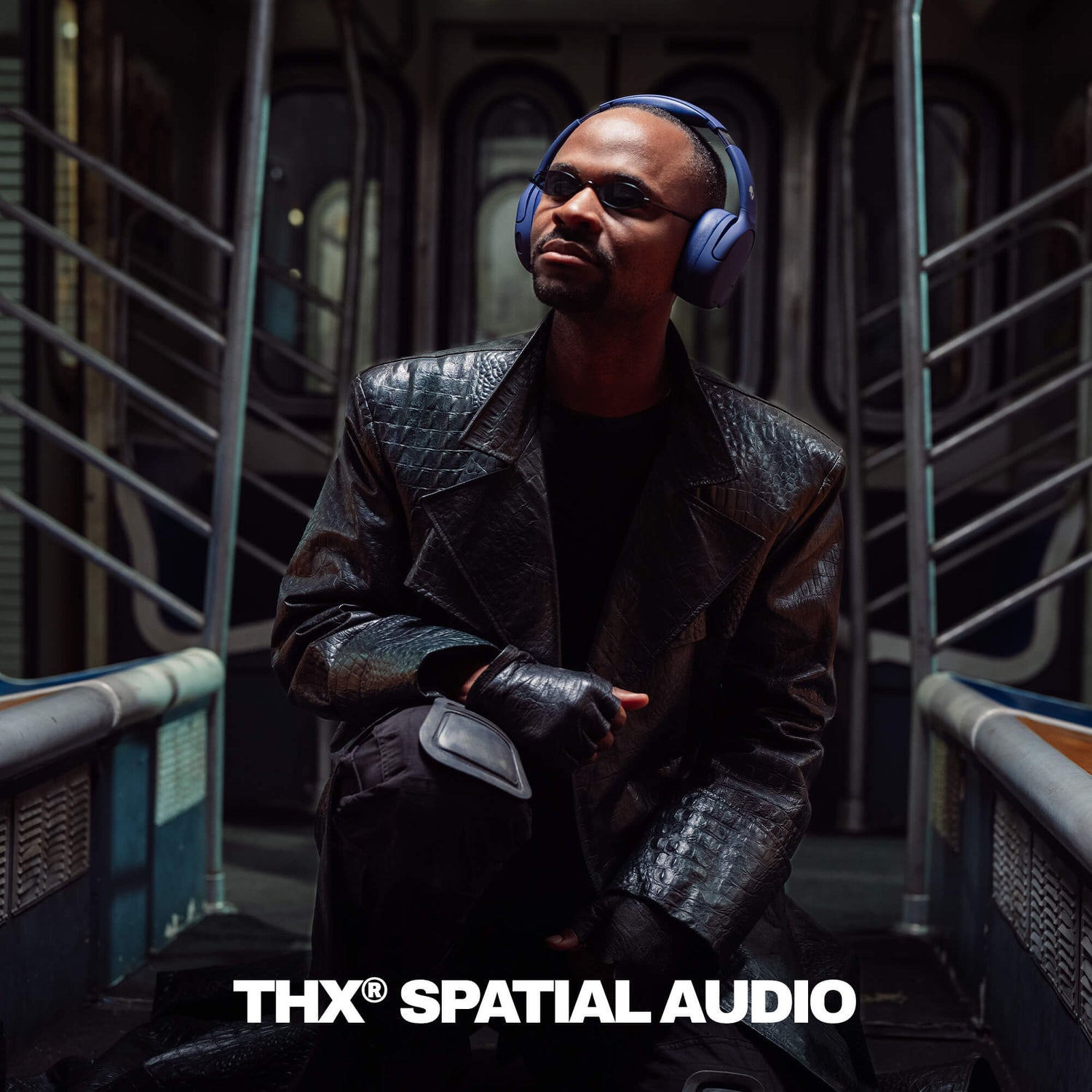 Person wearing Crusher 720 headphones and a dark coat in a futuristic setting with 'THX Spatial Audio' branding. | Future