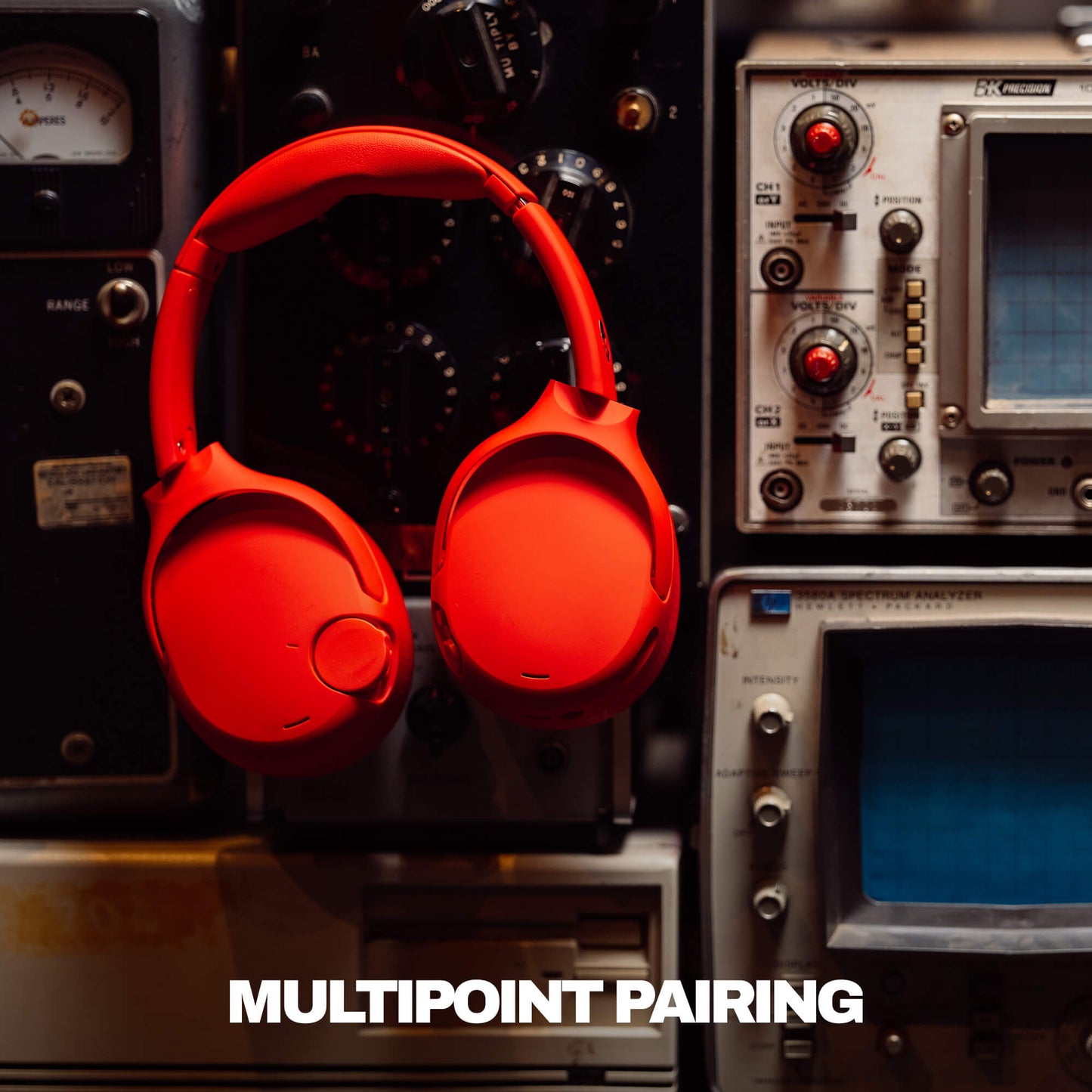 Red Crusher 720headphones on a vintage electronic equipment background with 'MULTIPOINT PAIRING' text. | Plasma