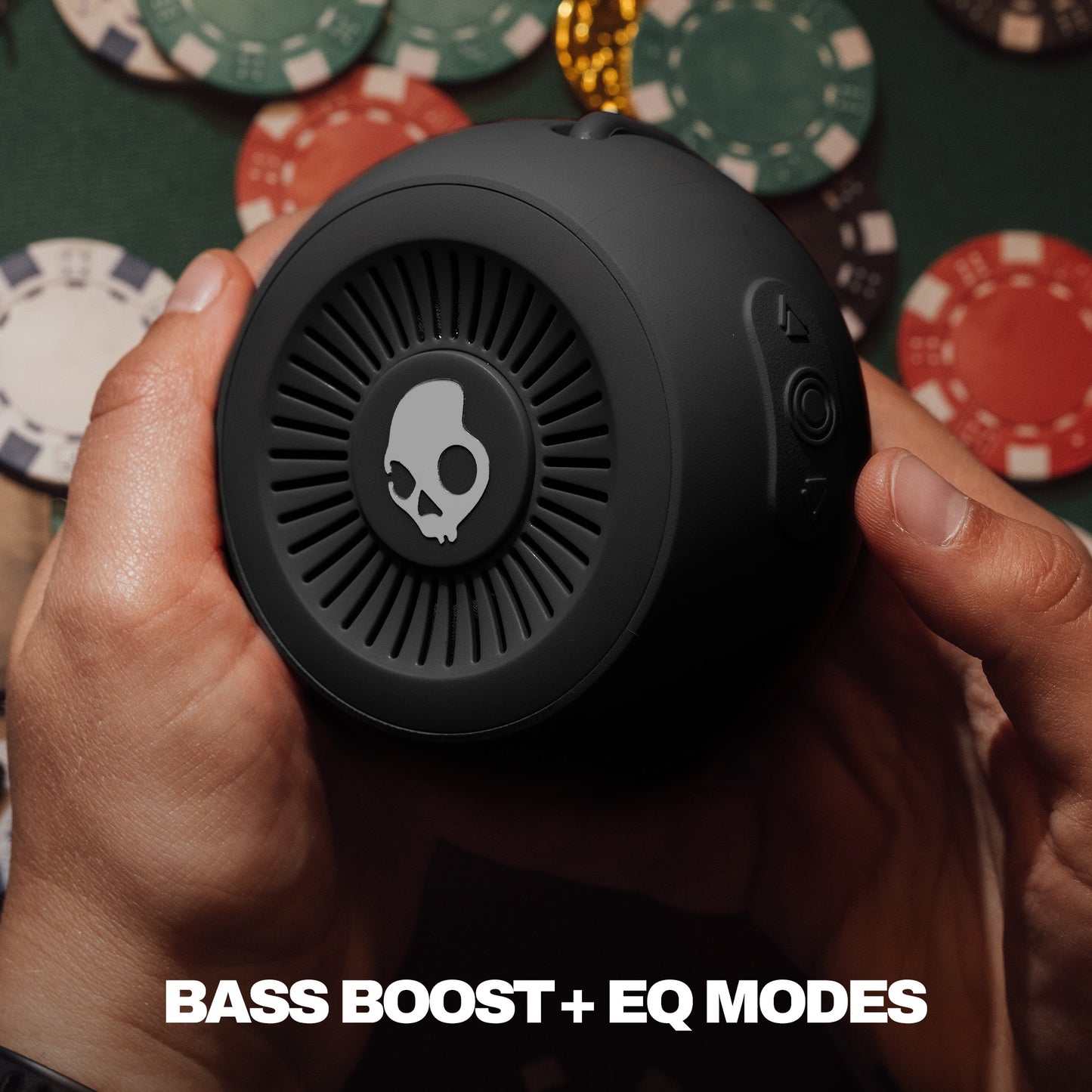 Person holding a black speaker with poker chips in the background | True Black