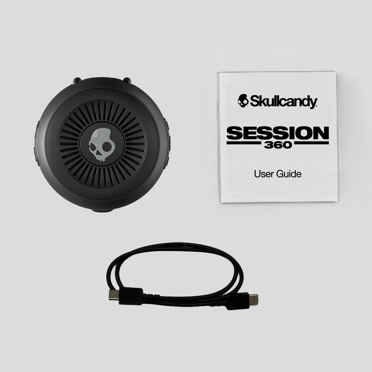 Skullcandy Session 360 headset with user guide on a light gray background | Cement