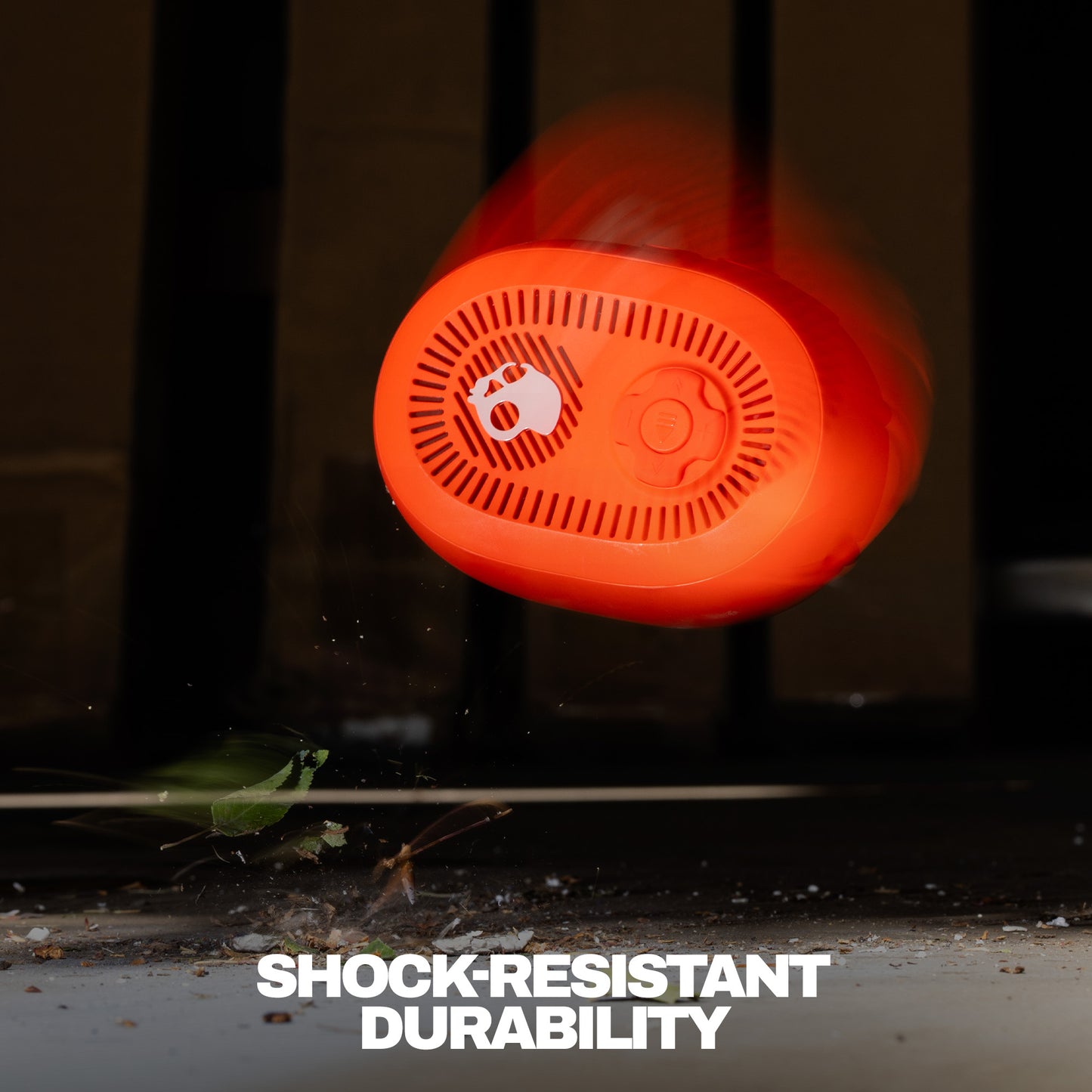 Orange speaker with 'Shock Resistant Durability' text on a dark background | Plasma