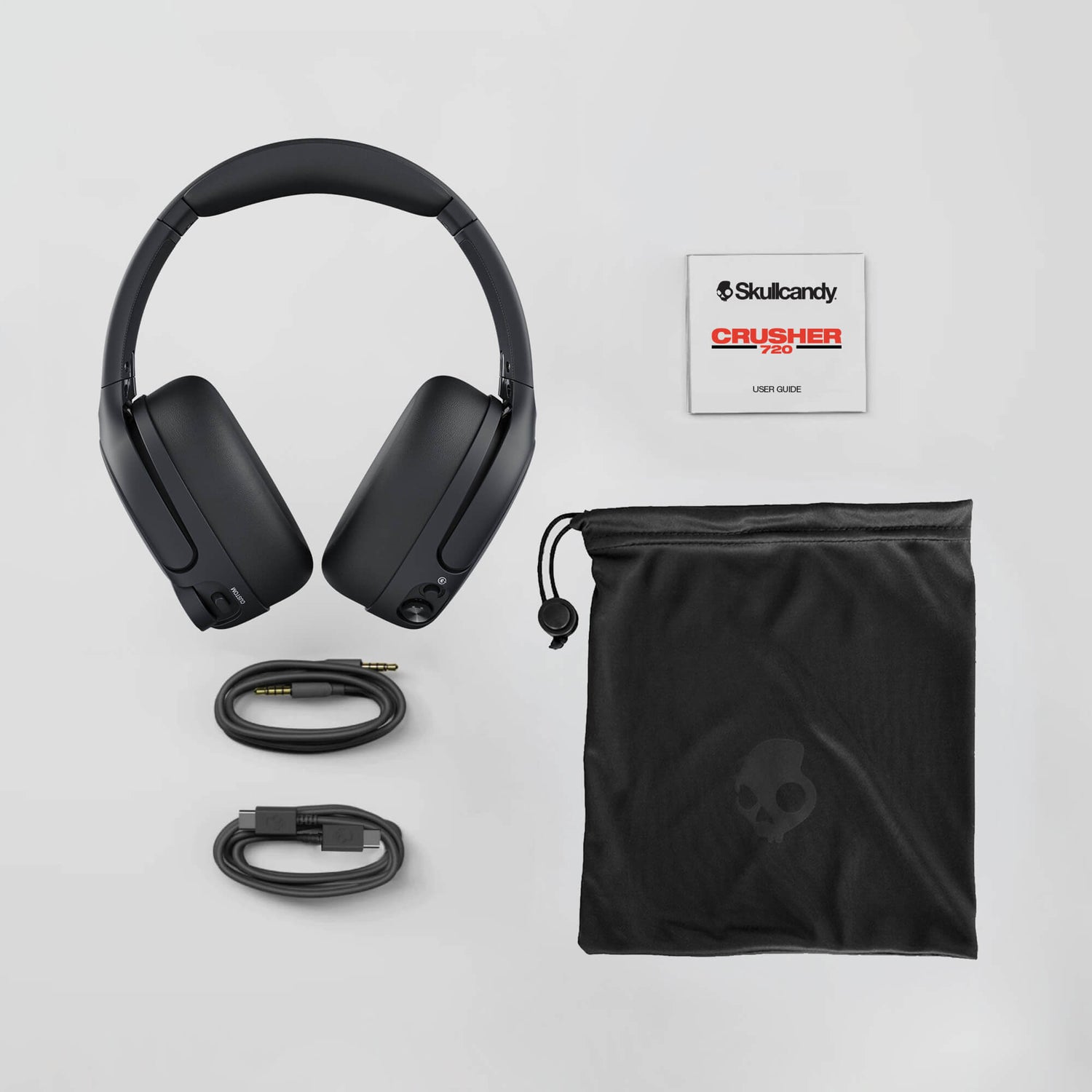 Skullcandy Crusher 720 headphones with accessories on a light gray background | Cement